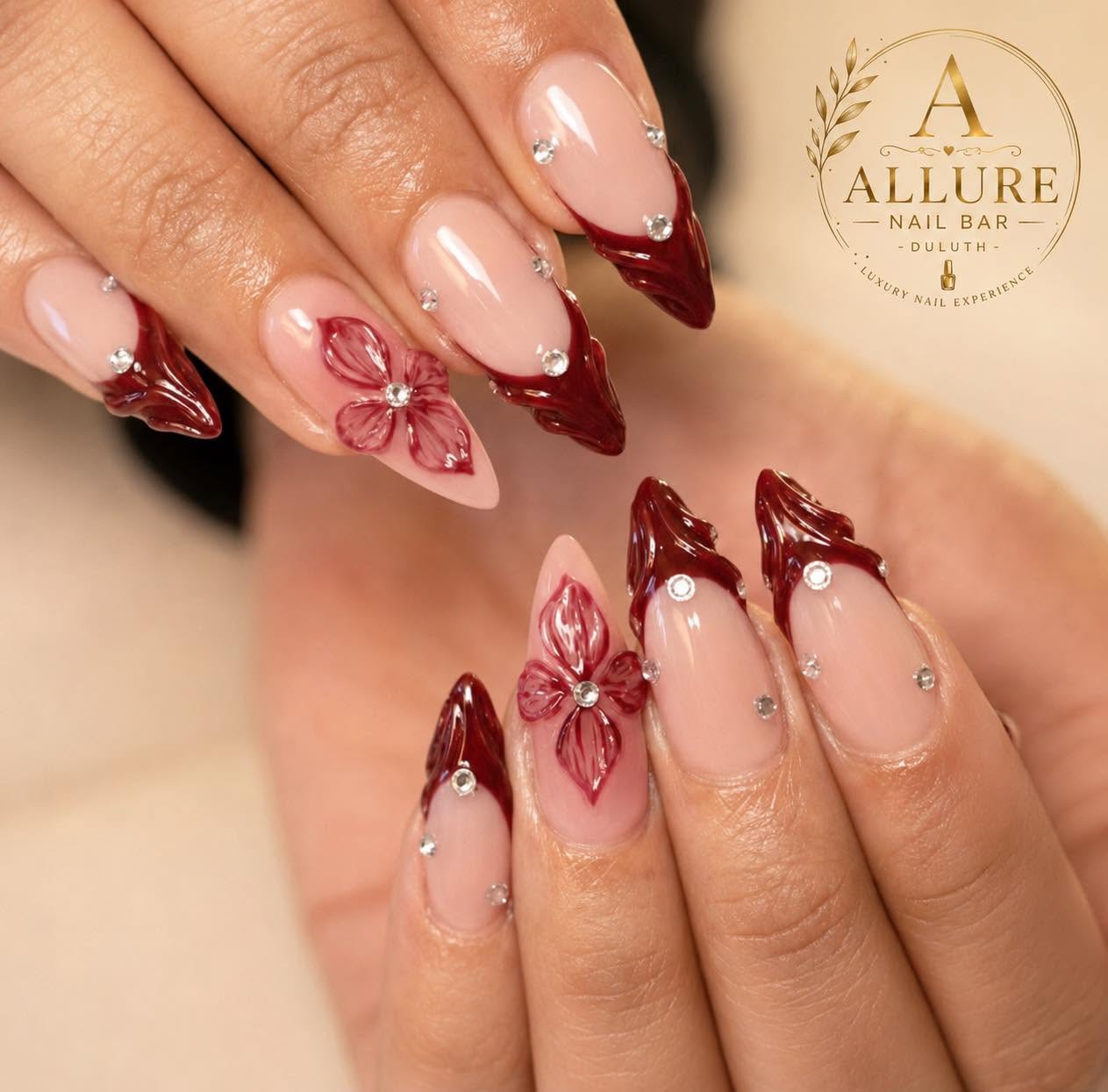 Dark red 3D floral nail art with crystal accents at Allure Nail Bar Duluth