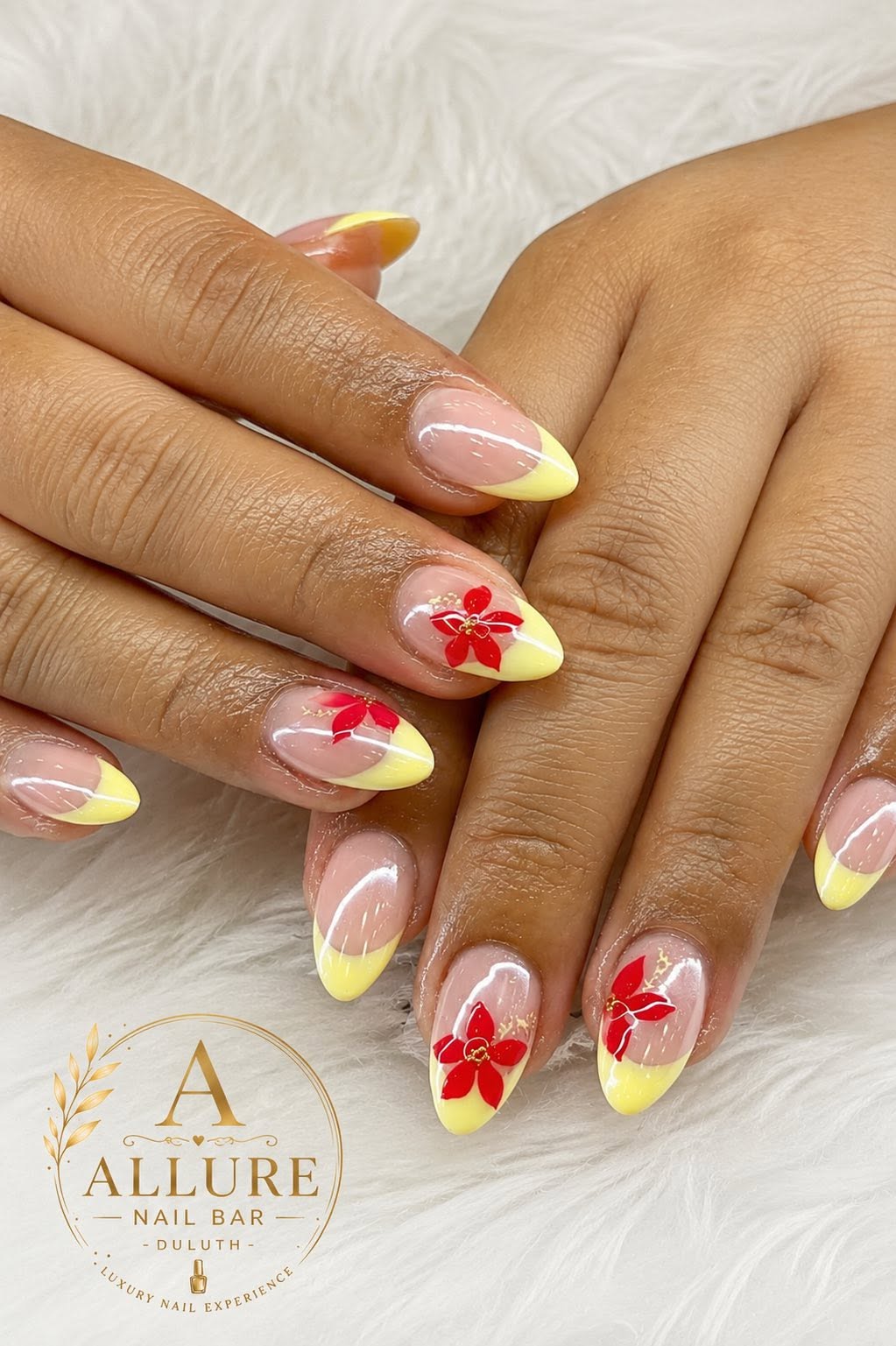 Yellow French tip manicure with red poinsettia flower nail art at Allure Nail Bar Duluth