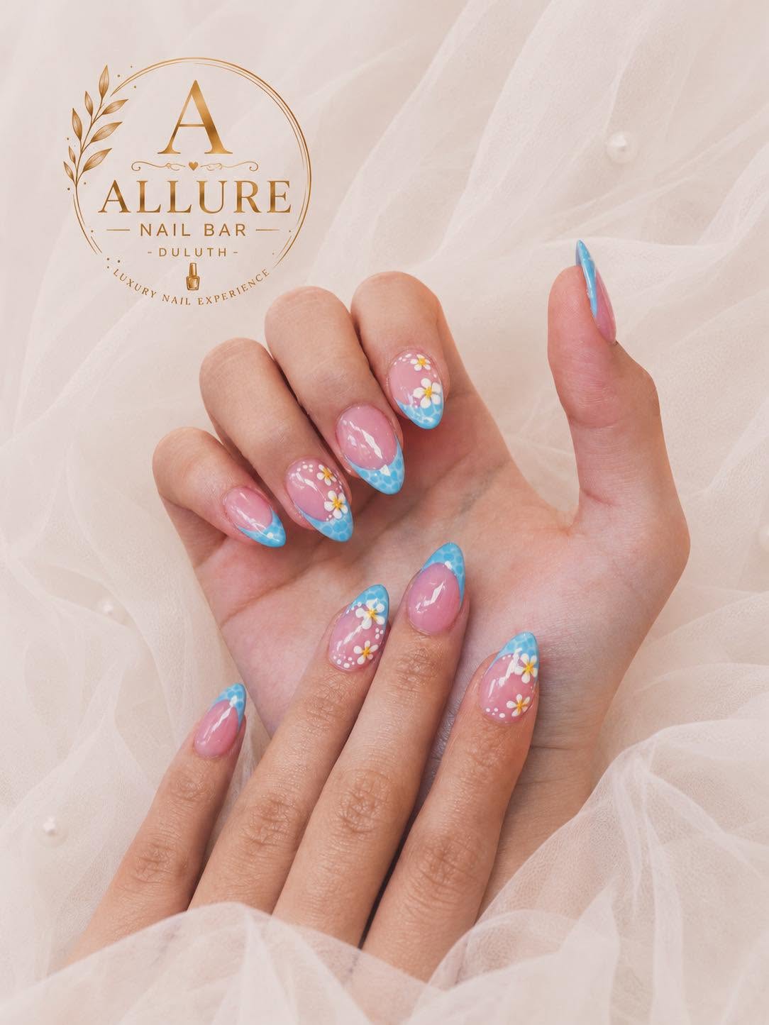 Blue French tip manicure with hand-painted daisy nail art at Allure Nail Bar Duluth